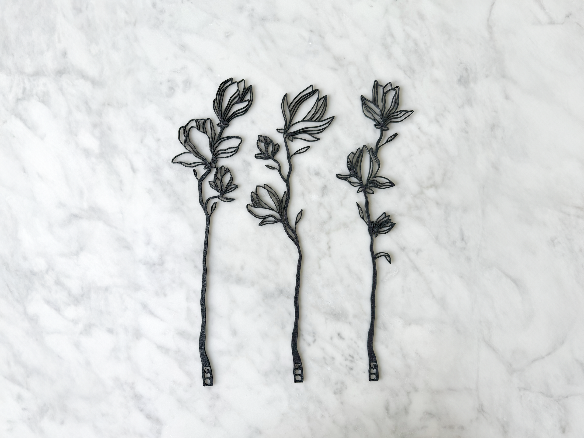 Minimalist 3D-printed flower silhouette wall art by OBJ STUDIO, crafted from sustainable plant-based materials. Modern black floral decor for eco-conscious homes.