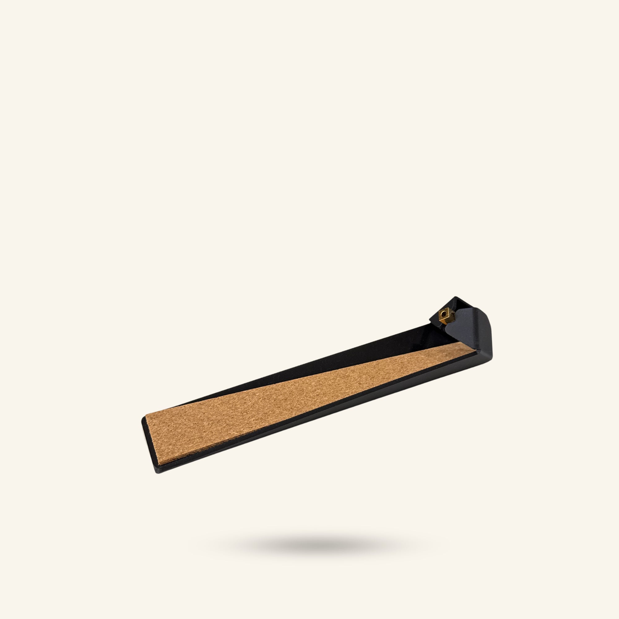 Cork incense holder with black frame on a white background