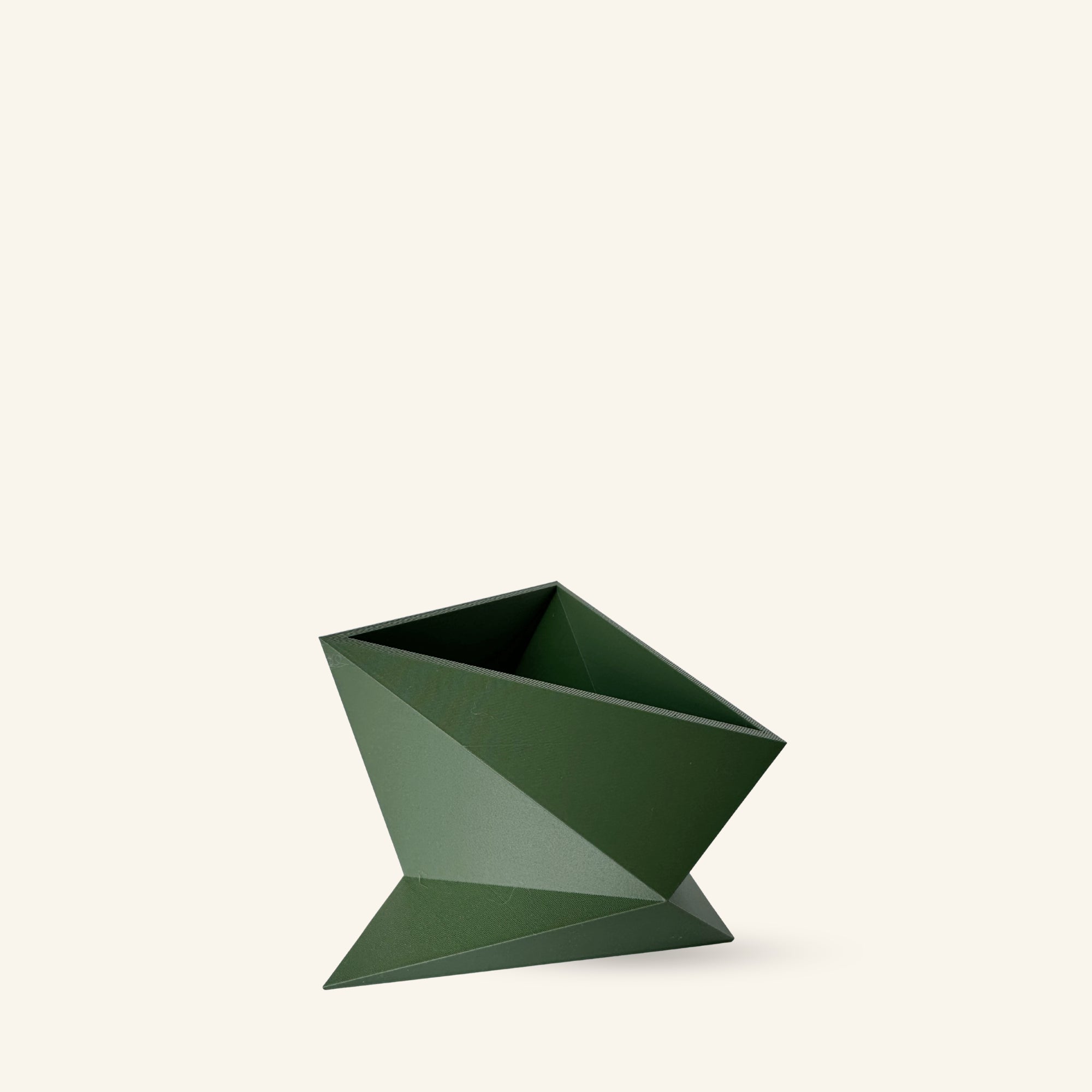 Green geometric planter on a white background