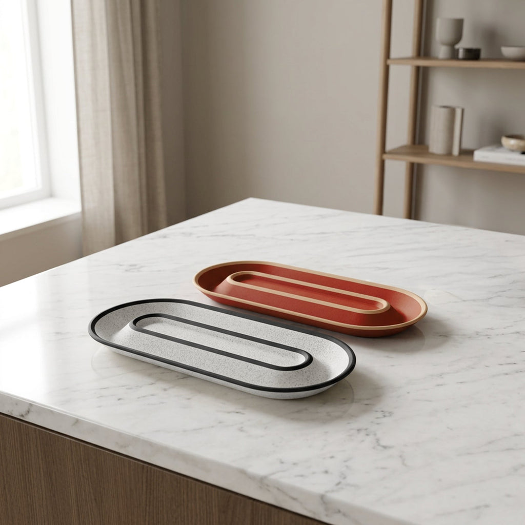 Two OBJ STUDIO Nook Tray 2Tone organizers in speckled white and terracotta on a marble countertop.
